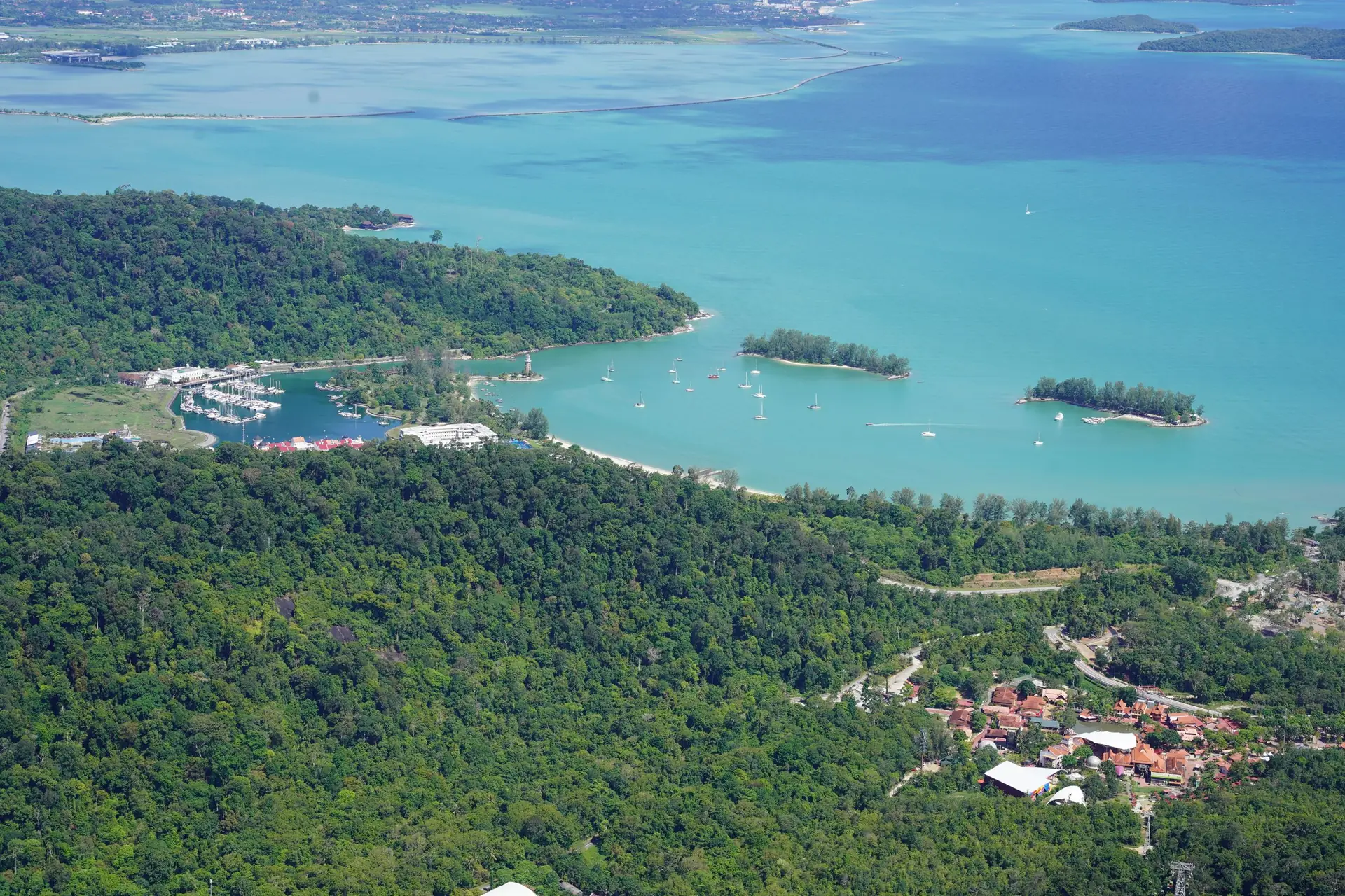 Scenic aerial view of Langkawi's coastline with vibrant greenery and marinas. Perfect for travel inspiration.