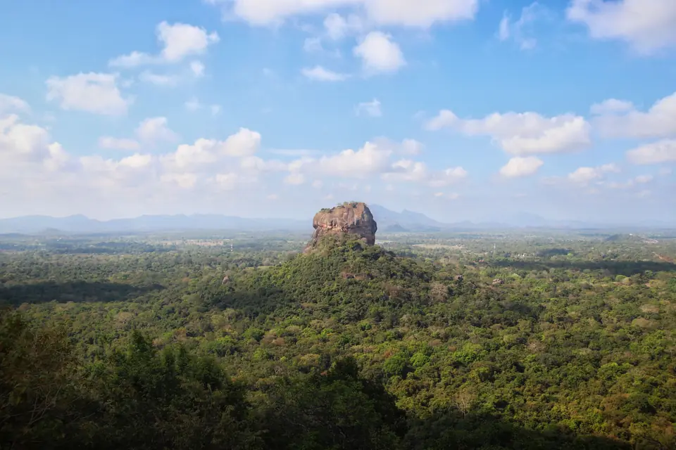 Breathtaking aerial view of the iconic Sigiriya Rock surrounded by lush forest in Sri Lanka.